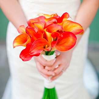 ramo de calas naranjas con una novia vestida de blanco